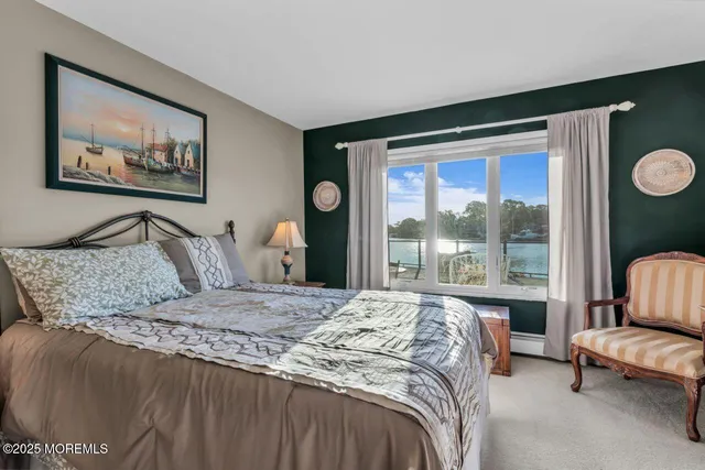 a bathroom with a granite countertop toilet sink and mirror