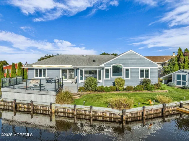 an aerial view of a house with a yard and lake view
