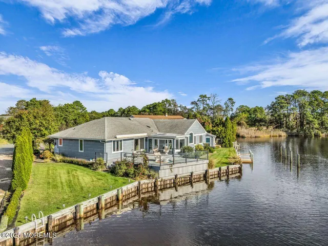 a view of a lake with boats and trees all around