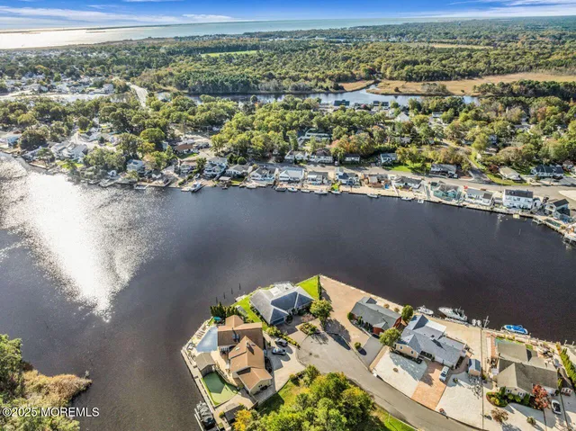 an aerial view of a house with a lake view