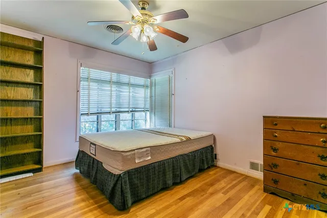 a room with a bed and a dresser