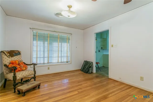 a view of a room with gym equipment and windows