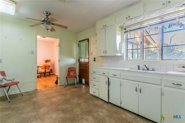 a en suite bathroom with a sink and a large mirror