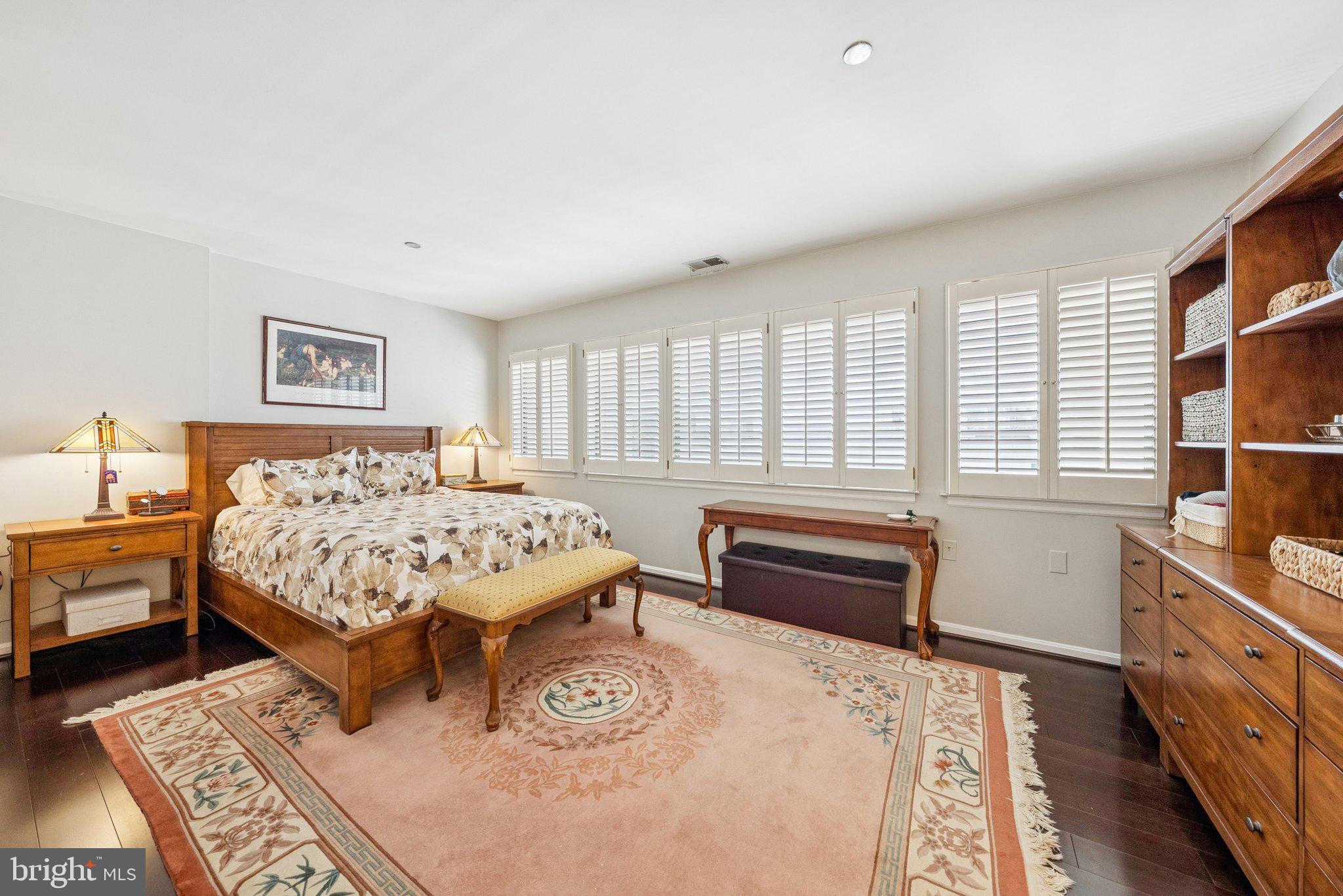 1301 North Courthouse Road, Unit 1810 Arlington, VA 22201 - Photo 13 of 29 a bedroom with a bed and wooden floor