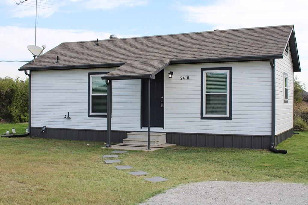a view of a house with a backyard
