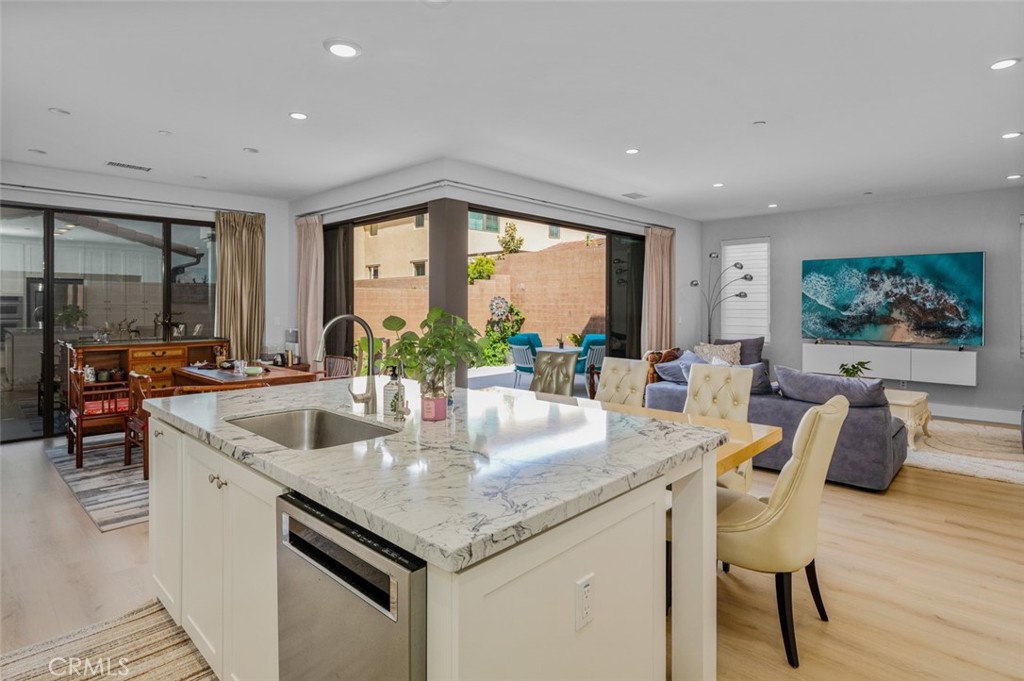 107 Tritone Irvine, CA 92602 - Photo 11 of 15 a kitchen with stainless steel appliances granite countertop a sink and a large window