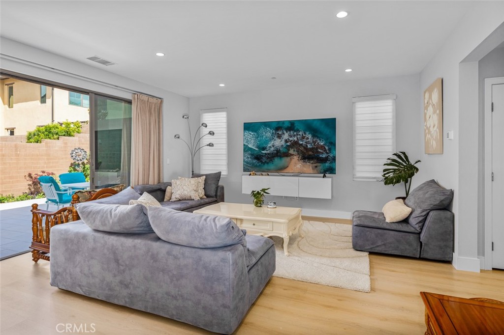 107 Tritone Irvine, CA 92602 - Photo 8 of 15 a living room with furniture and a flat screen tv