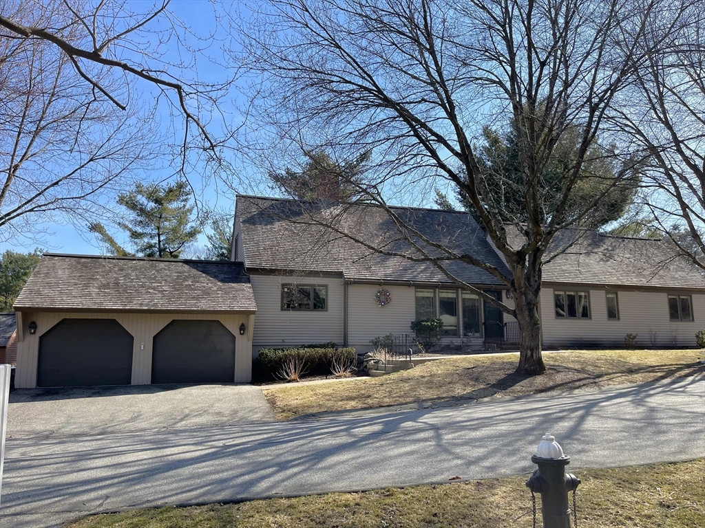 93 Potter Pond, Unit 93 Lexington, MA 02421 - Photo 1 of 42 a house with trees in front of it