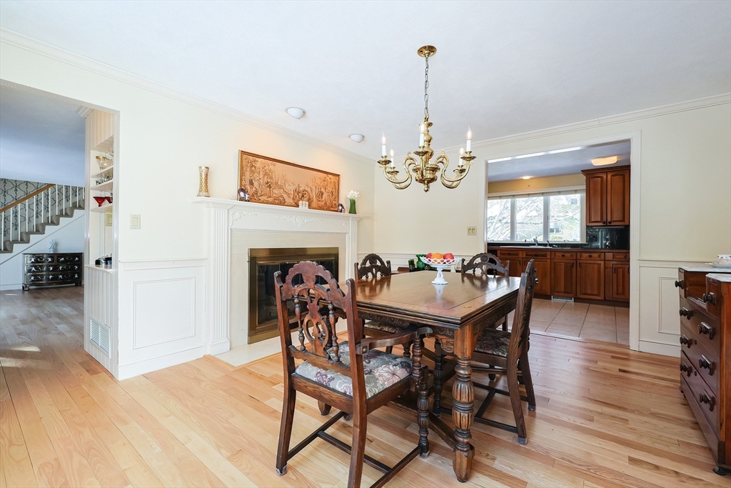 93 Potter Pond, Unit 93 Lexington, MA 02421 - Photo 13 of 42 a dining room with furniture a chandelier and wooden floor