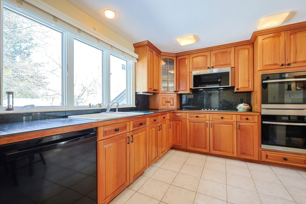 93 Potter Pond, Unit 93 Lexington, MA 02421 - Photo 15 of 42 a kitchen with stainless steel appliances a sink stove and microwave