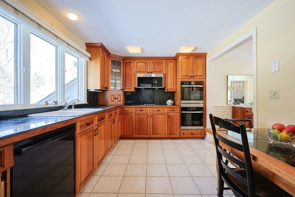 93 Potter Pond, Unit 93 Lexington, MA 02421 - Photo 18 of 42 a large kitchen with stainless steel appliances granite countertop a large counter top a stove a sink and a refrigerator