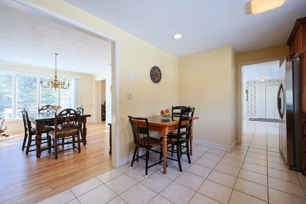 93 Potter Pond, Unit 93 Lexington, MA 02421 - Photo 19 of 42 a view of a dining room with furniture and wooden floor