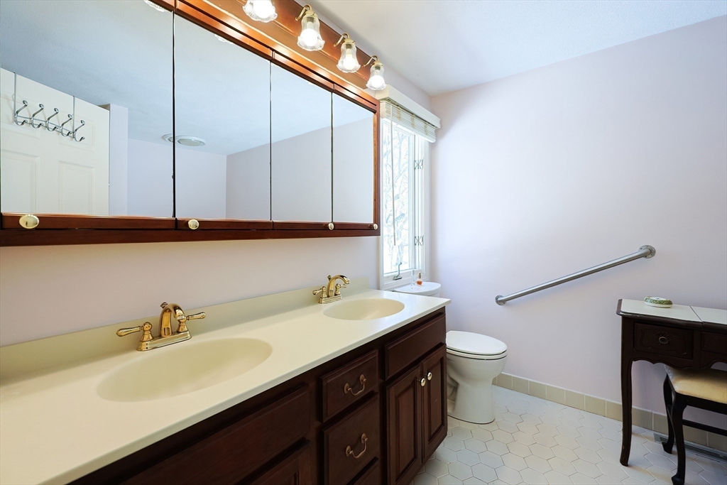 93 Potter Pond, Unit 93 Lexington, MA 02421 - Photo 26 of 42 a bathroom with a sink and a mirror