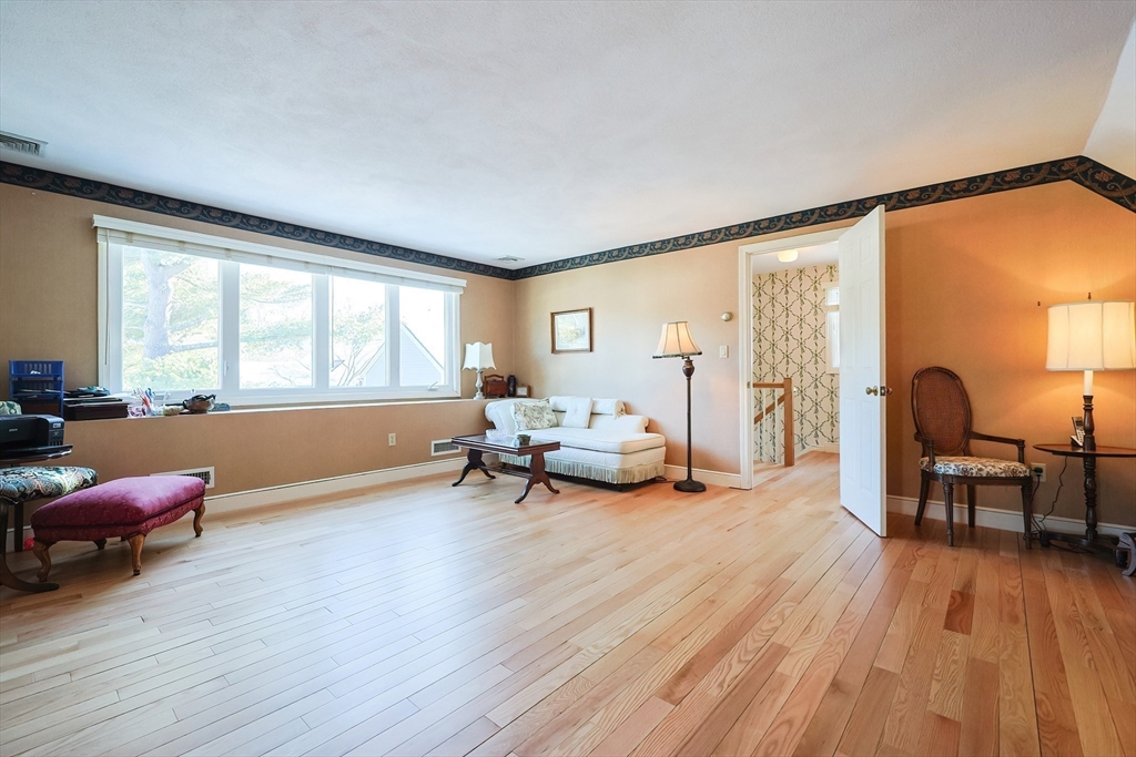 93 Potter Pond, Unit 93 Lexington, MA 02421 - Photo 31 of 42 a living room with furniture and a wooden floor
