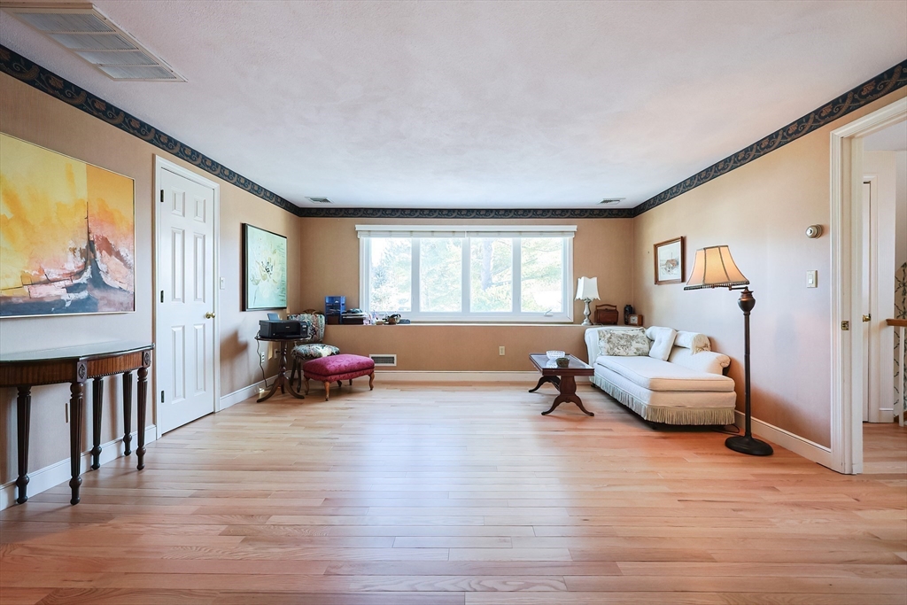 93 Potter Pond, Unit 93 Lexington, MA 02421 - Photo 32 of 42 a living room with furniture and a wooden floor