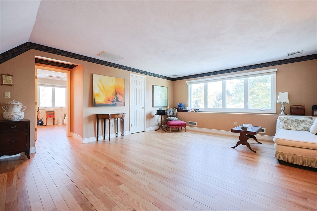 93 Potter Pond, Unit 93 Lexington, MA 02421 - Photo 33 of 42 a living room with furniture and a wooden floor