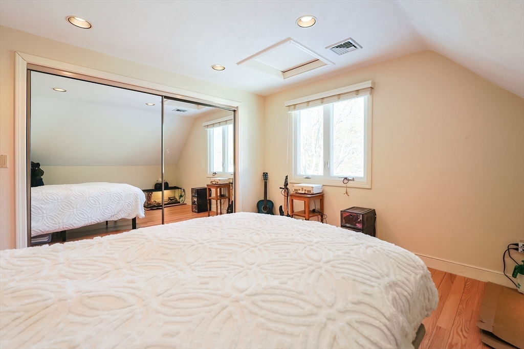 93 Potter Pond, Unit 93 Lexington, MA 02421 - Photo 36 of 42 a bedroom with a large bed and a window