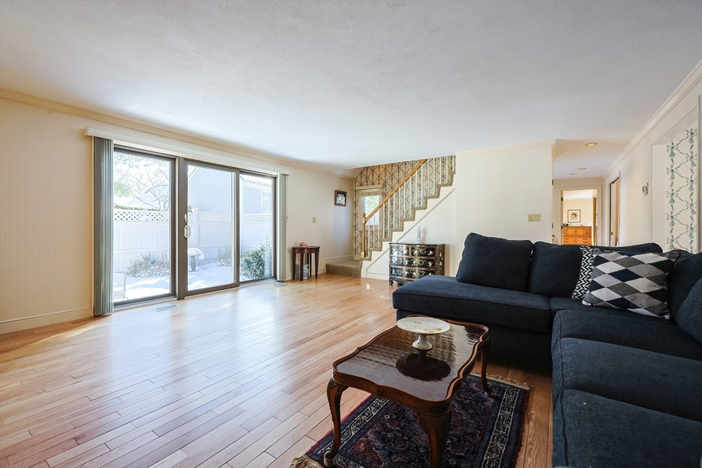 93 Potter Pond, Unit 93 Lexington, MA 02421 - Photo 8 of 42 a living room with furniture and wooden floor