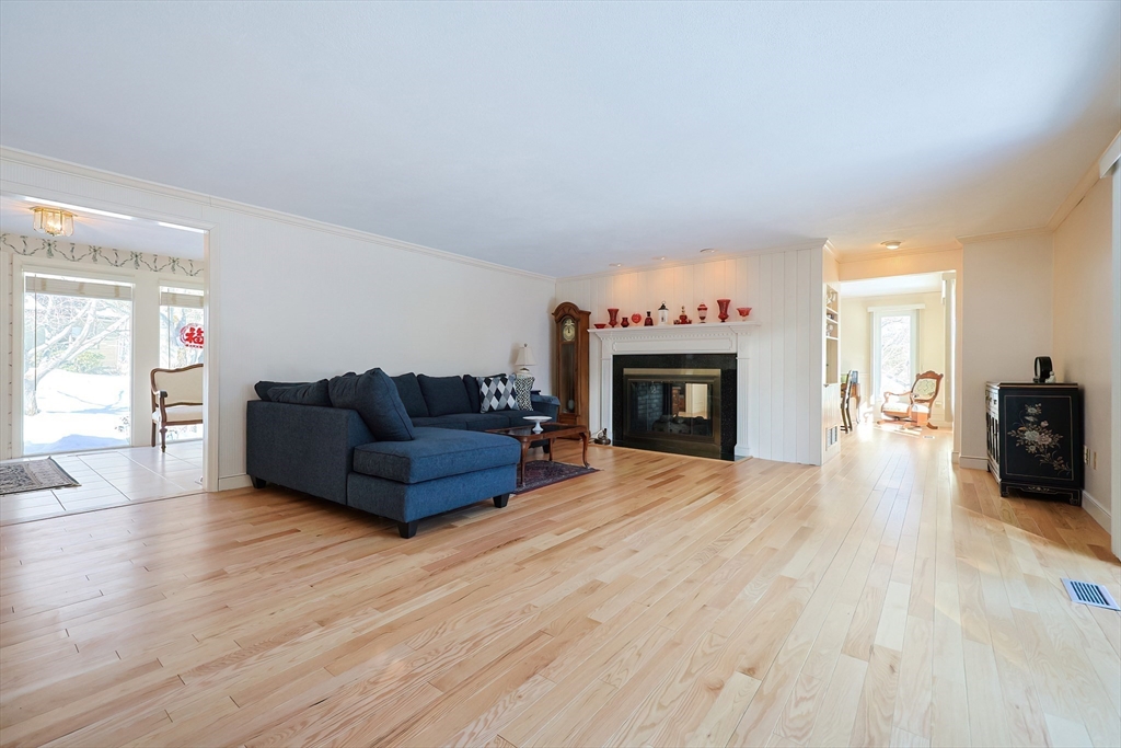 93 Potter Pond, Unit 93 Lexington, MA 02421 - Photo 10 of 42 a living room with furniture and a fireplace