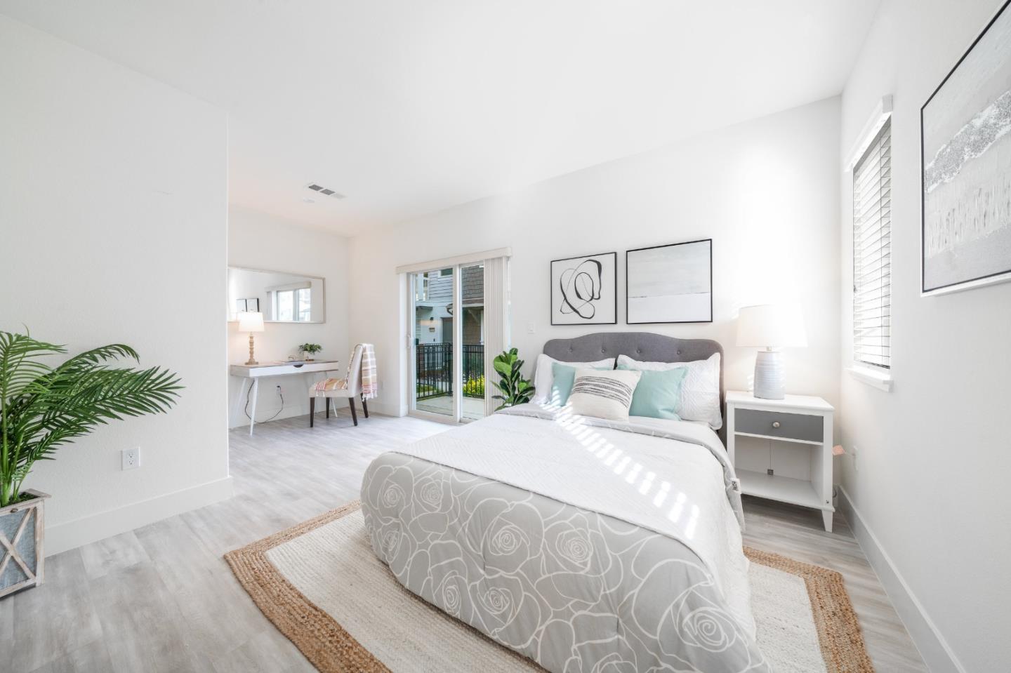 8553 Seawind Way Newark, CA 94560 - Photo 5 of 30 a bedroom with a large bed and a potted plant