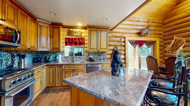 a kitchen with lots of counter top space and wooden floor