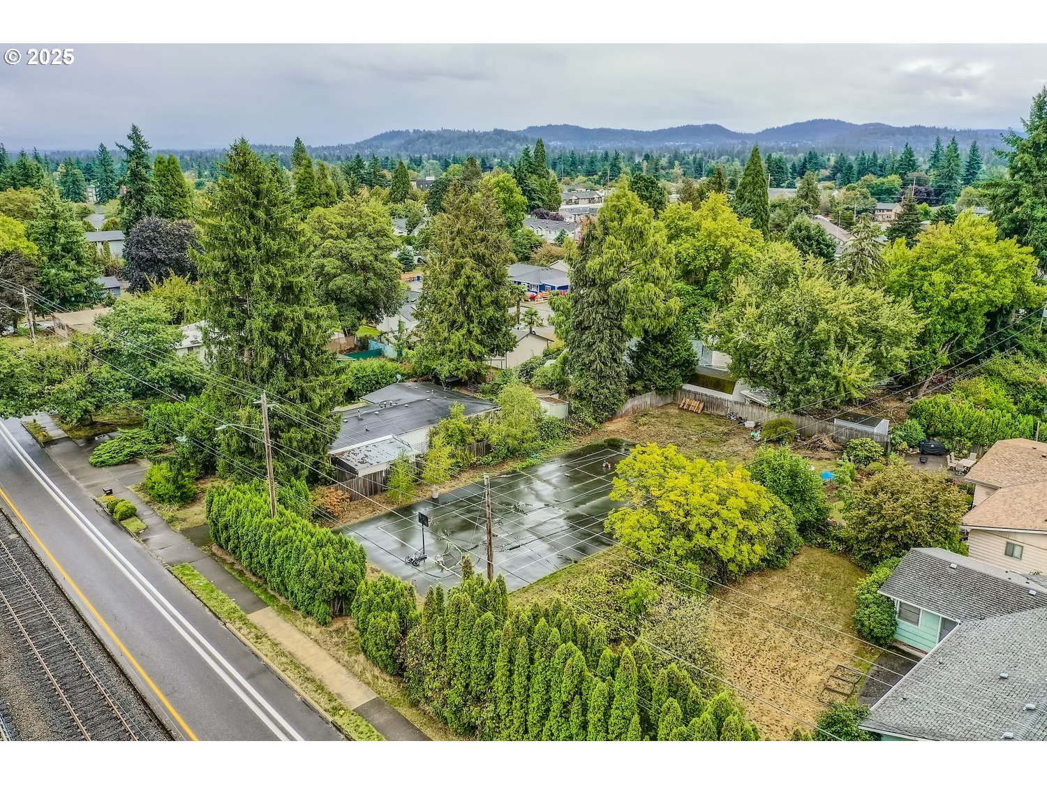15590 East Burnside Street Portland, OR 97233 - Photo 4 of 11 a view of a city with lush green forest