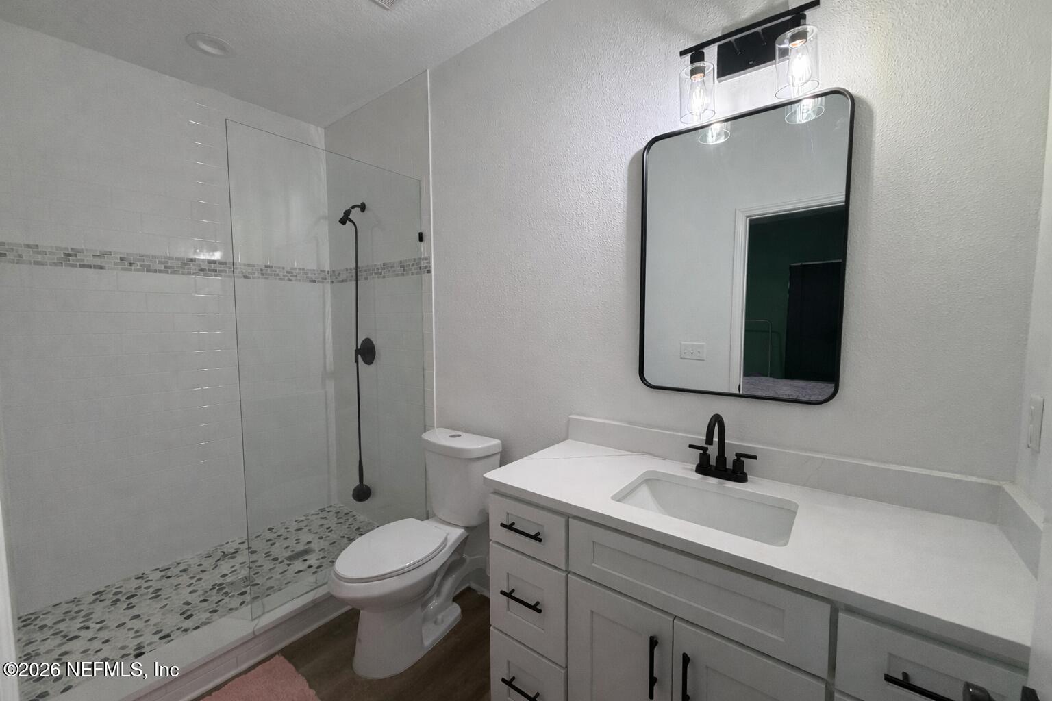 5012 Laurel Street Middleburg, FL 32068 - Photo 15 of 33 a bathroom with a toilet sink and shower