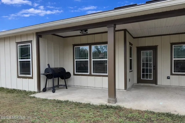 a front view of a house with a yard garage and table