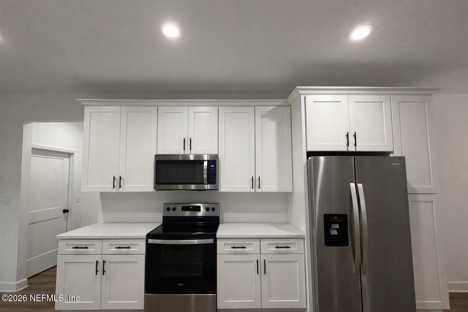 5012 Laurel Street Middleburg, FL 32068 - Photo 6 of 33 a kitchen with a refrigerator and a stove top oven