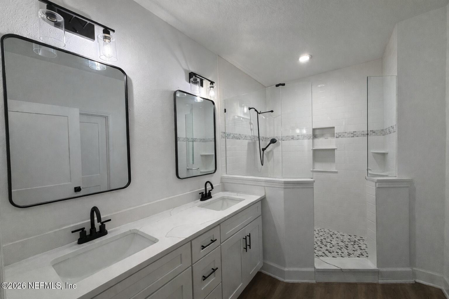 5012 Laurel Street Middleburg, FL 32068 - Photo 10 of 33 a bathroom with a double vanity sink mirror and shower