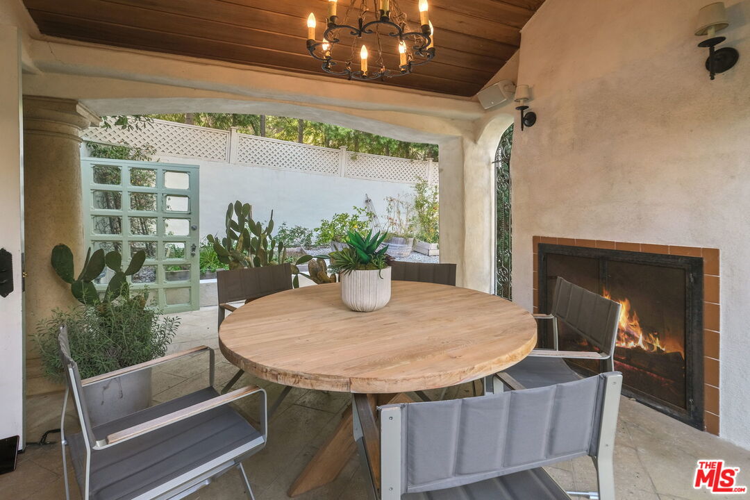 9308 Readcrest Drive Beverly Hills, CA 90210 - Photo 22 of 46 a dining room with furniture and a potted plant