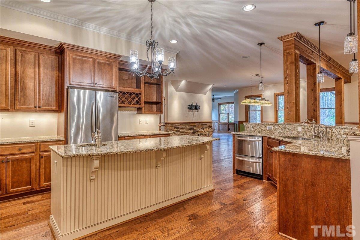 3220 Mossy Ridge Court Raleigh, NC 27613 - Photo 22 of 30 a kitchen with stainless steel appliances granite countertop a sink refrigerator and cabinets