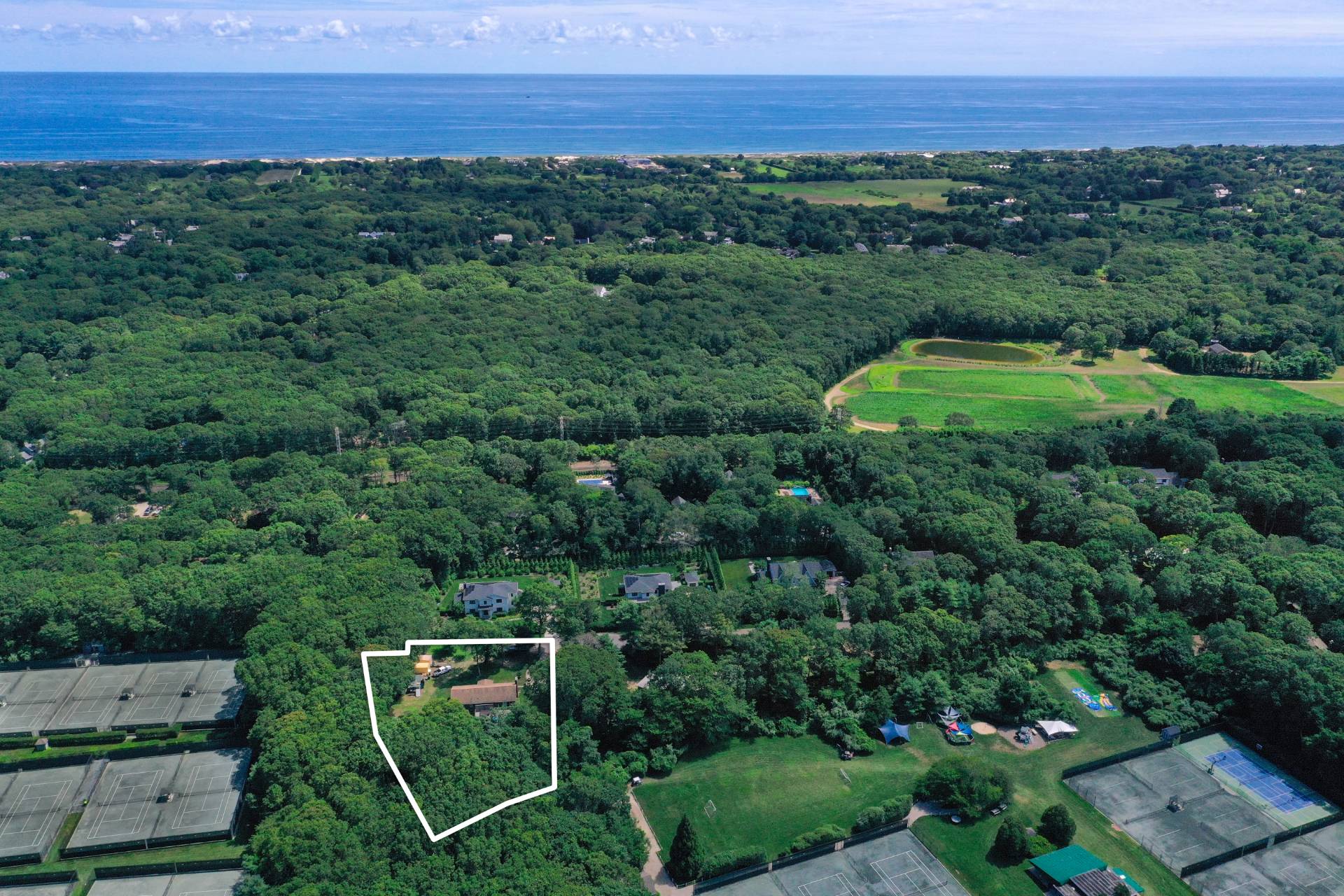 75 Edwards Avenue East Hampton, NY 11937 - Photo 2 of 27 an aerial view of a house with a yard