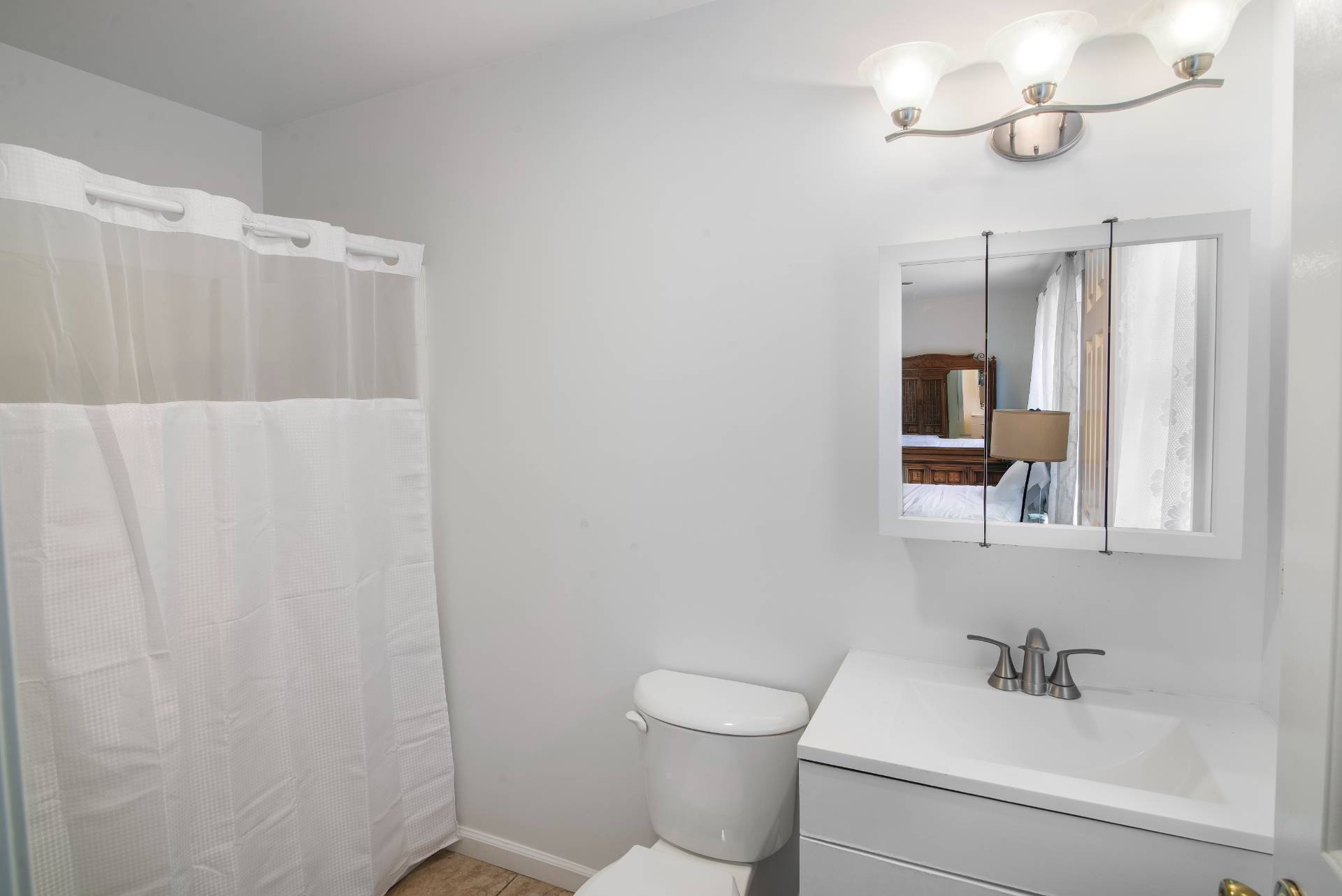 75 Edwards Avenue East Hampton, NY 11937 - Photo 24 of 27 a bathroom with a sink a toilet and mirror
