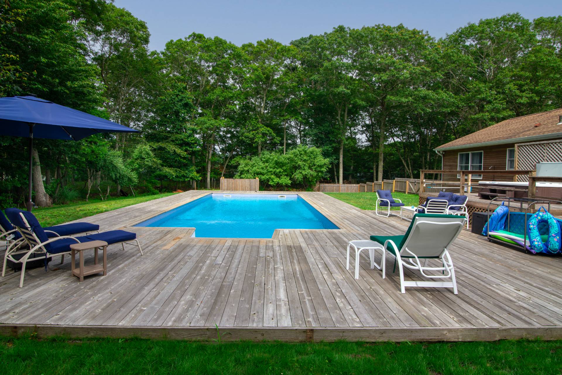 75 Edwards Avenue East Hampton, NY 11937 - Photo 27 of 27 a chair and table sitting in backyard of house