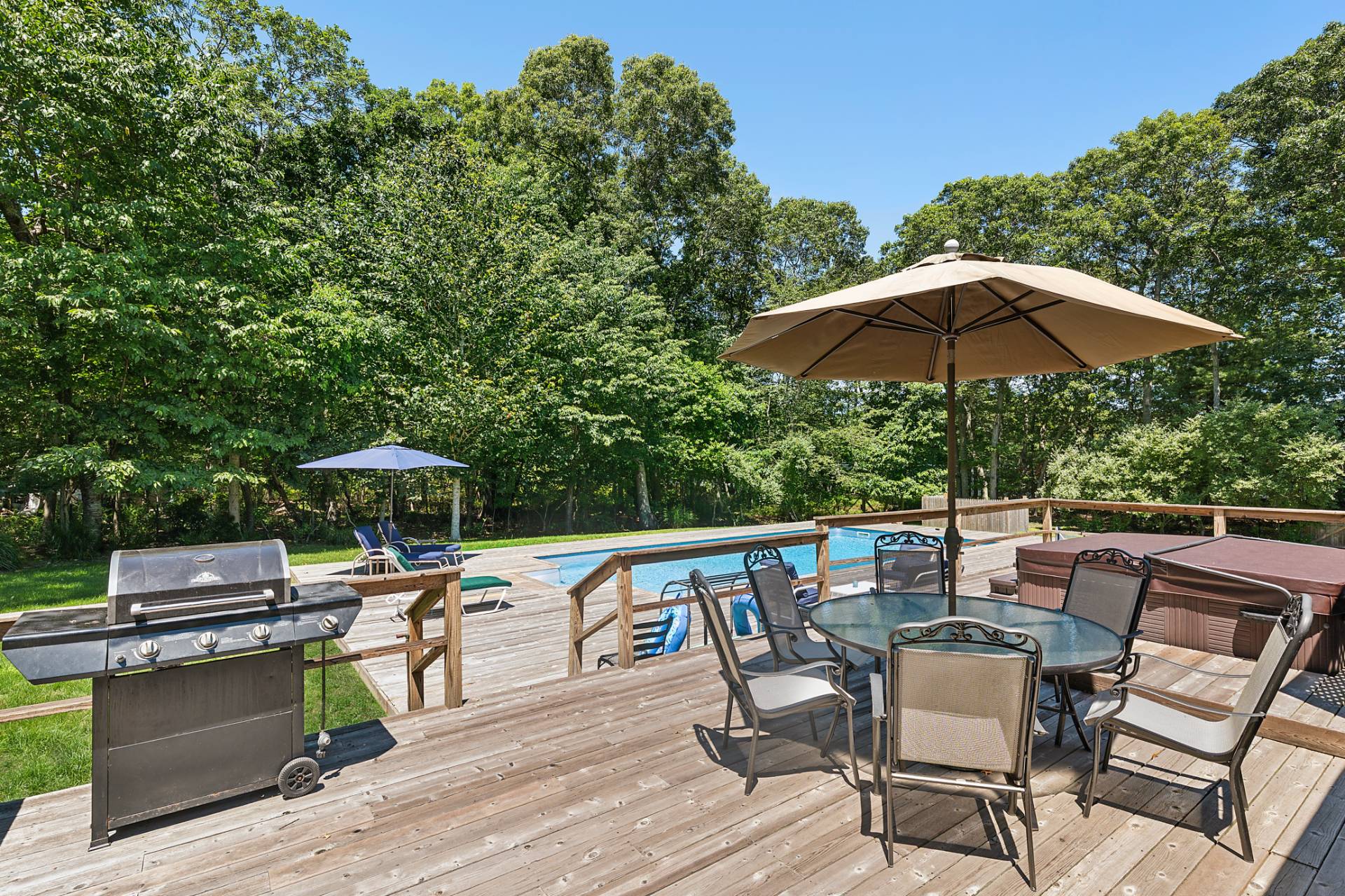 75 Edwards Avenue East Hampton, NY 11937 - Photo 3 of 27 a patio with a patio table and chairs