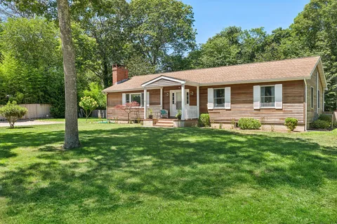 a front view of house with yard and green space