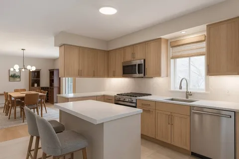 a kitchen with a sink stove and white cabinets