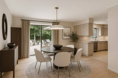 a dining room with furniture a chandelier and wooden floor