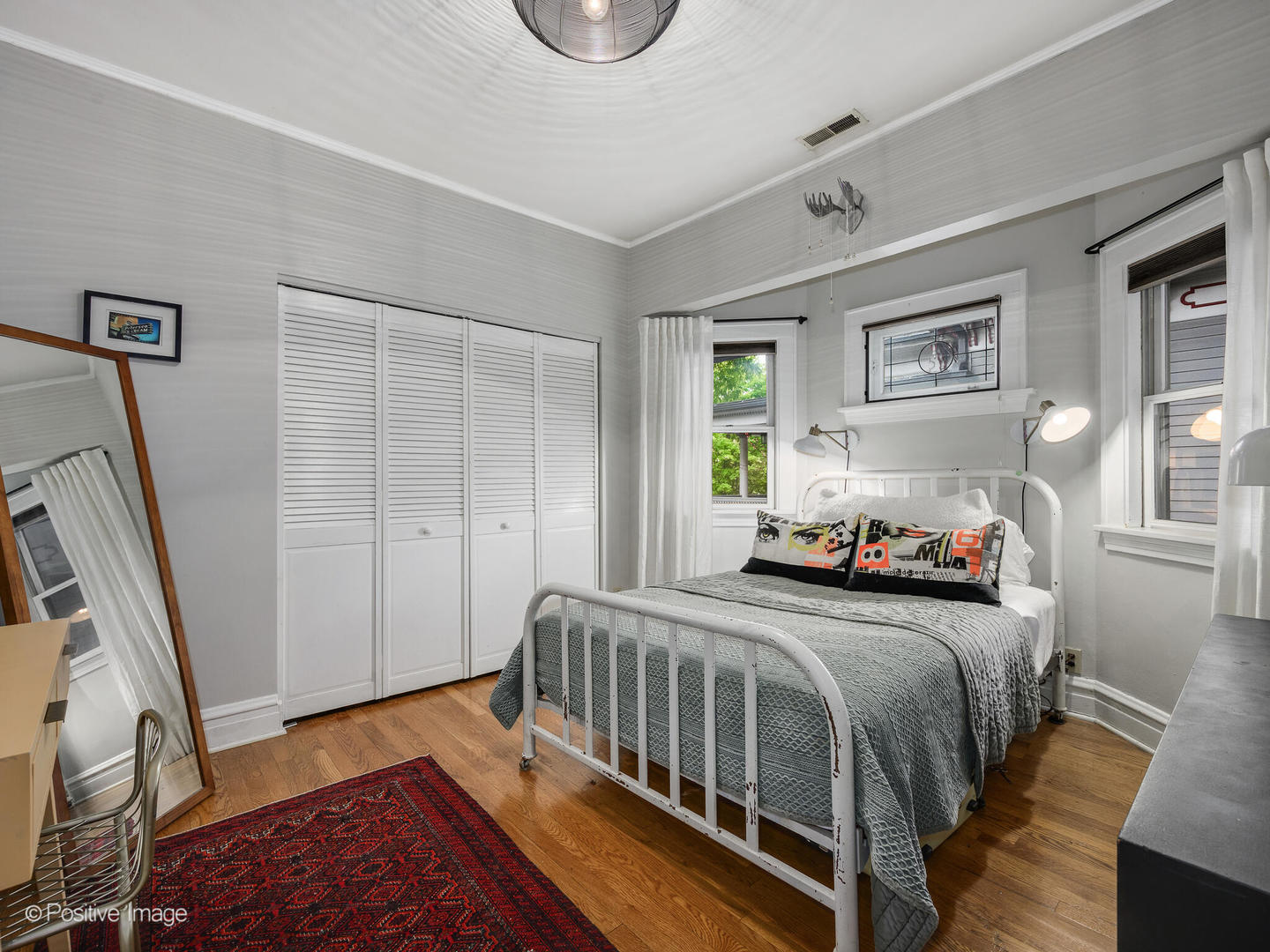 225 Clinton Avenue Oak Park, IL 60302 - Photo 28 of 37 a bedroom with a bed next to a window with wooden floor