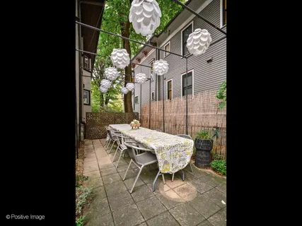 a view of a backyard with a bench and potted plants