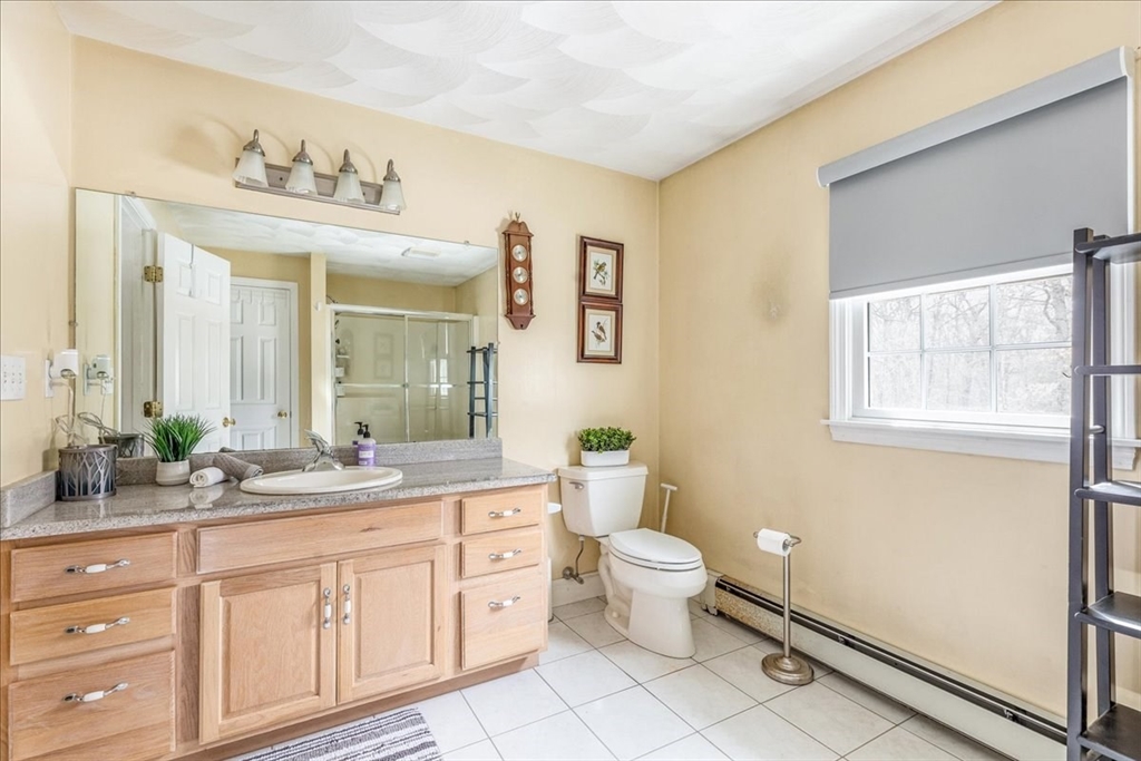 5 Lynn Street Taunton, MA 02780 - Photo 17 of 26 a bathroom with a sink a toilet and a mirror