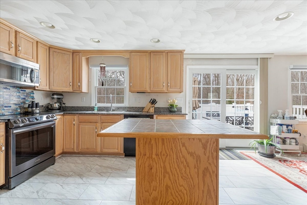 5 Lynn Street Taunton, MA 02780 - Photo 6 of 26 a large kitchen with stainless steel appliances granite countertop a lot of counter space and a sink