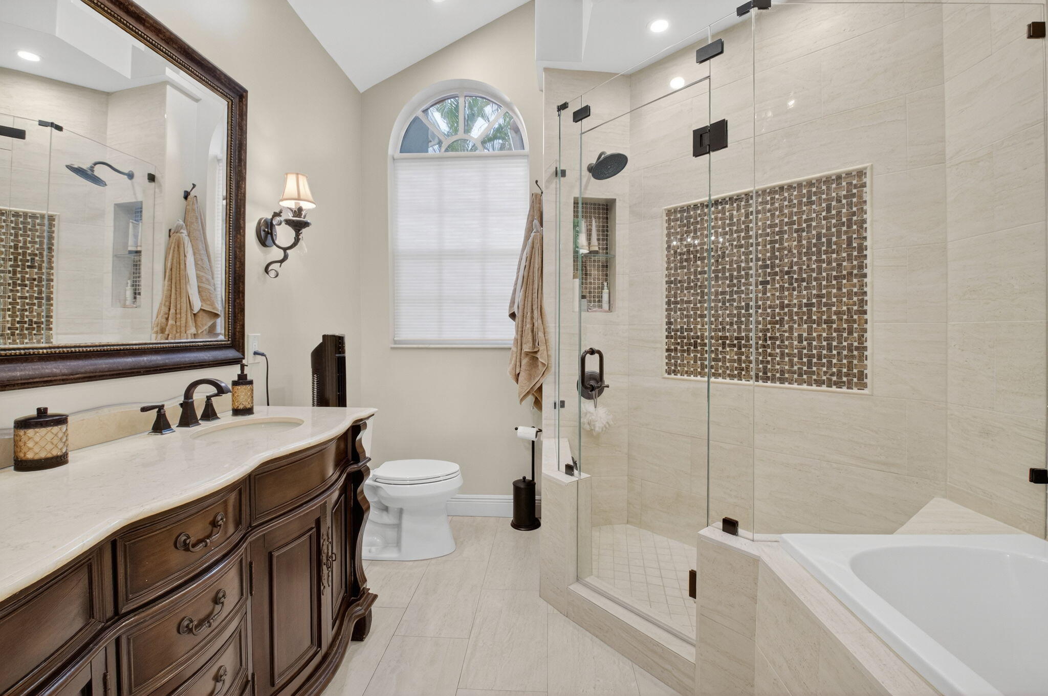 2500 Northwest 66th Drive Boca Raton, FL 33496 - Photo 23 of 45 a bathroom with a bathtub sink mirror vanity and toilet
