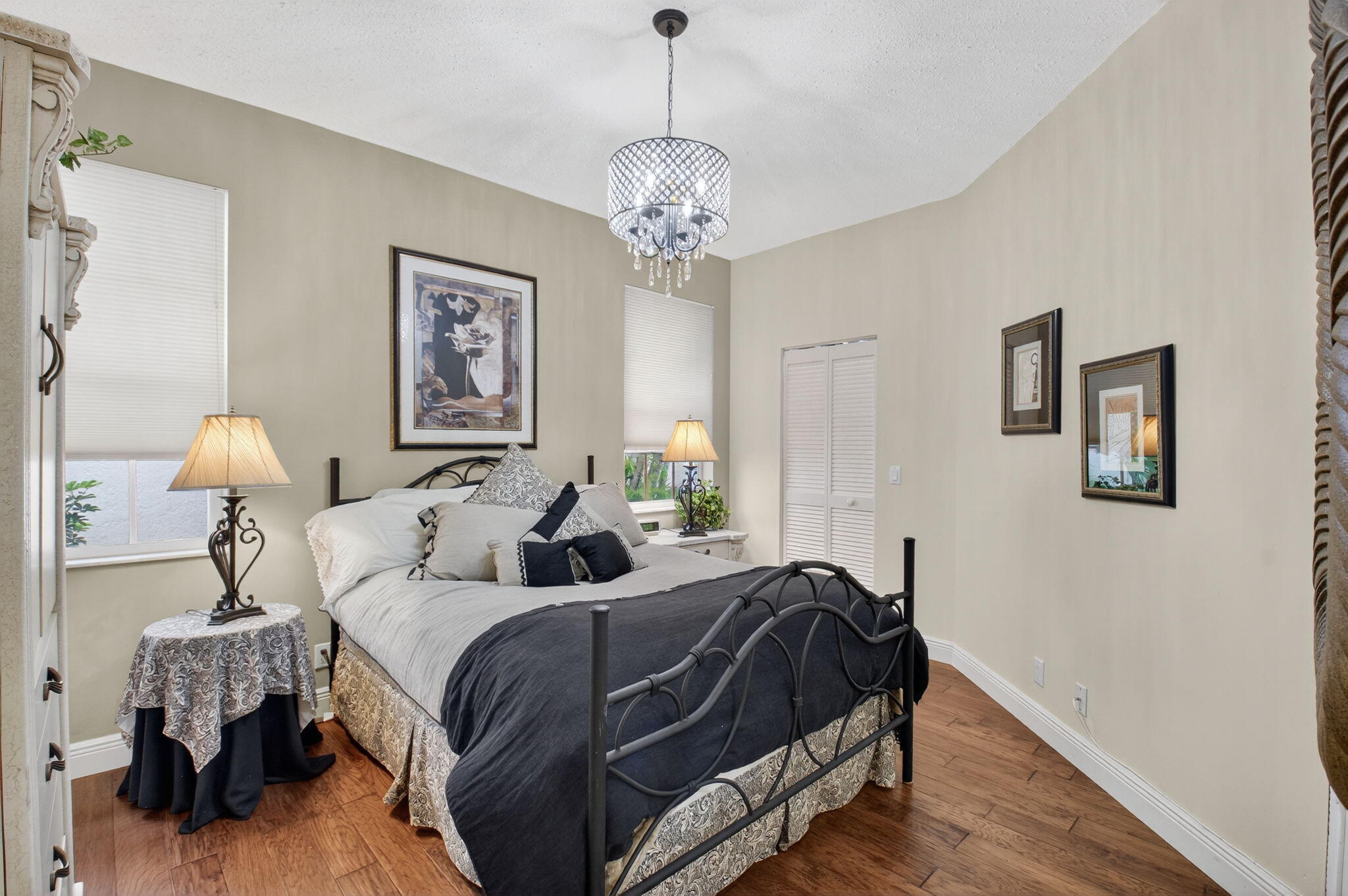 2500 Northwest 66th Drive Boca Raton, FL 33496 - Photo 27 of 45 a bed room with a bed and a chandelier