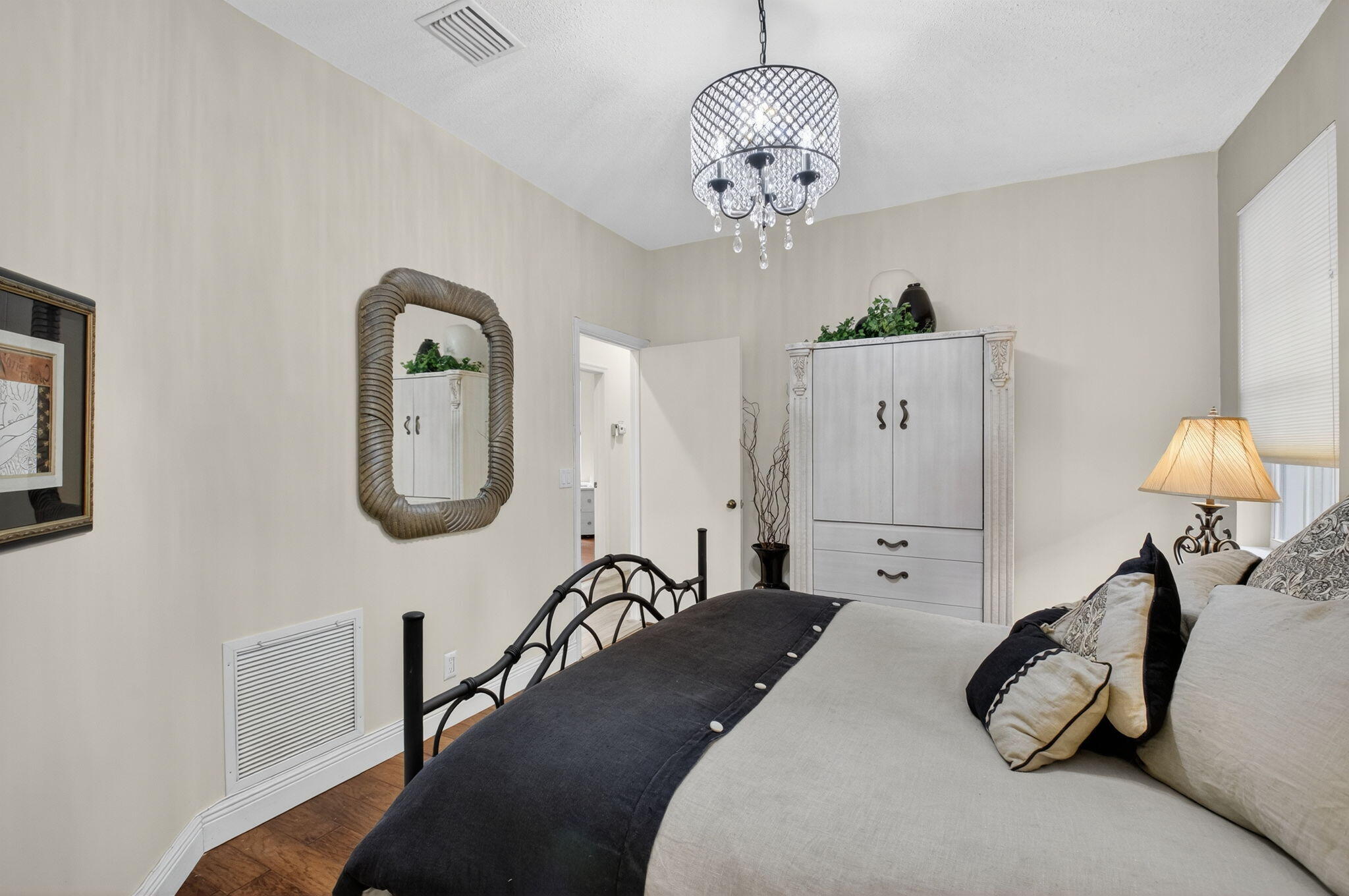 2500 Northwest 66th Drive Boca Raton, FL 33496 - Photo 28 of 45 a bedroom with a bed and a chandelier