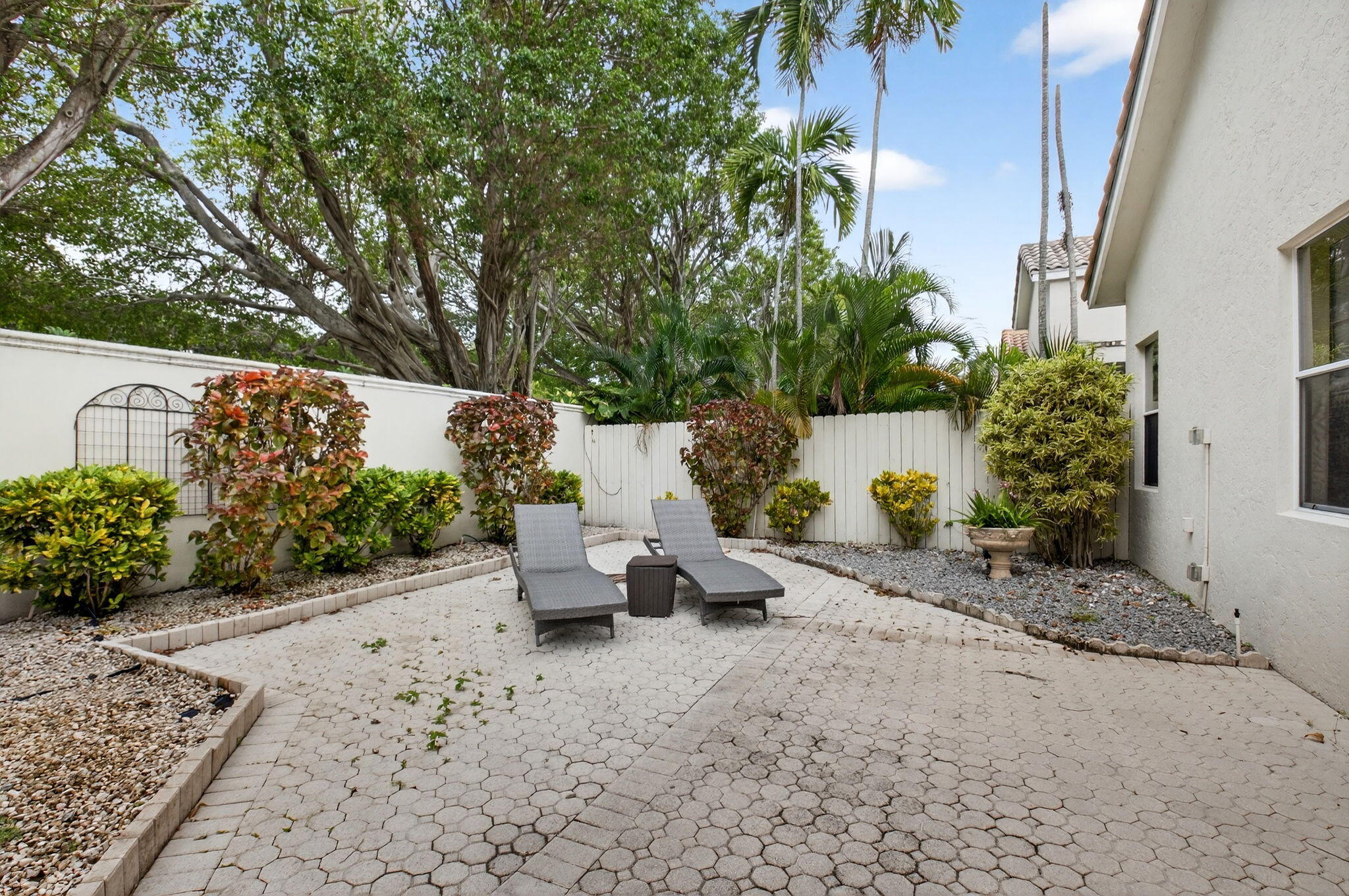 2500 Northwest 66th Drive Boca Raton, FL 33496 - Photo 35 of 45 a view of a bench in a backyard of the house