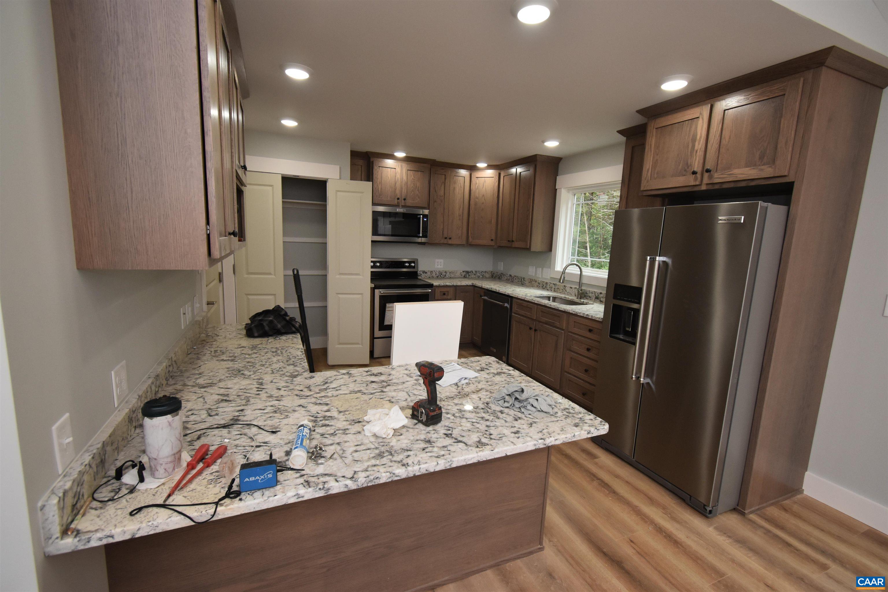 280 Farm Ridge Drive Ruckersville, VA 22968 - Photo 20 of 36 a kitchen with stainless steel appliances granite countertop a refrigerator and a sink