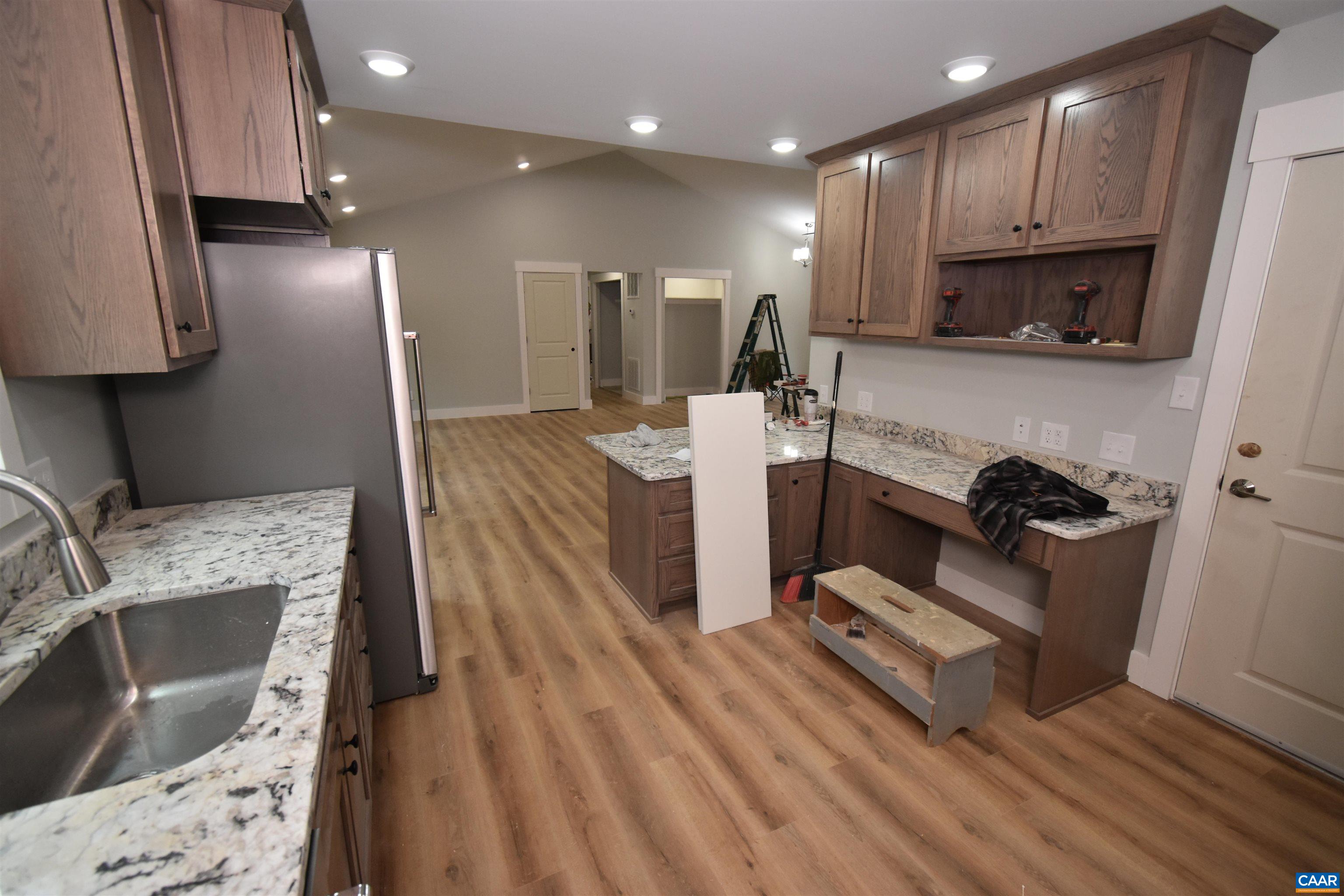 280 Farm Ridge Drive Ruckersville, VA 22968 - Photo 21 of 36 a kitchen with stainless steel appliances granite countertop a refrigerator a sink dishwasher a stove and a sink with wooden floor