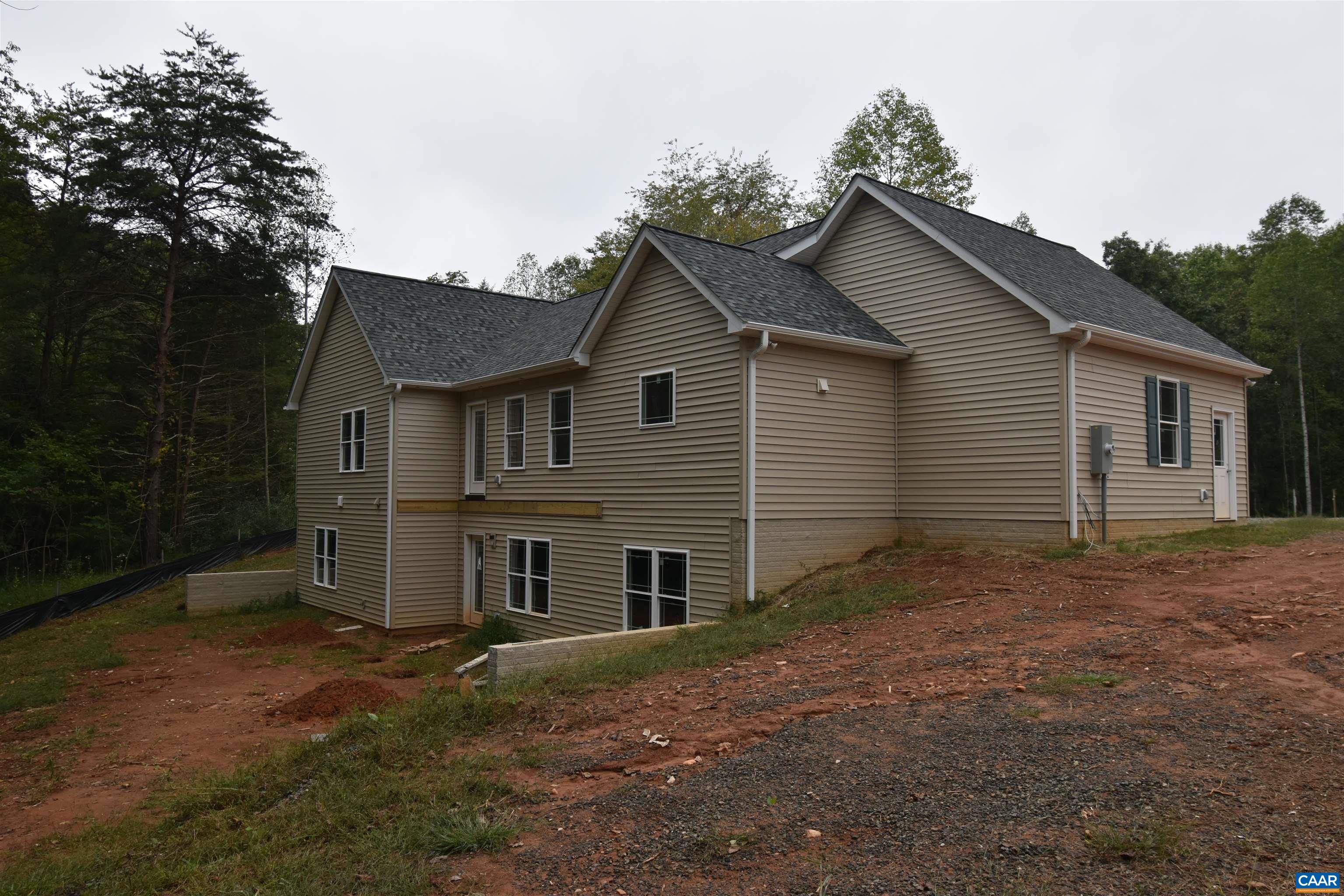 280 Farm Ridge Drive Ruckersville, VA 22968 - Photo 8 of 36 a view of a yard in front of a house with large windows